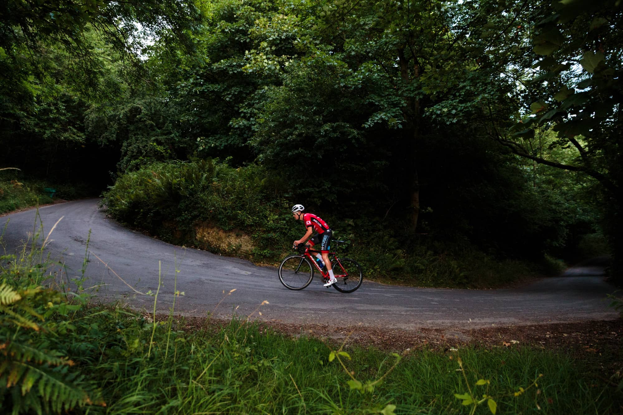Cyclist riding uphill. Photo by Chris Kendall on Unsplash