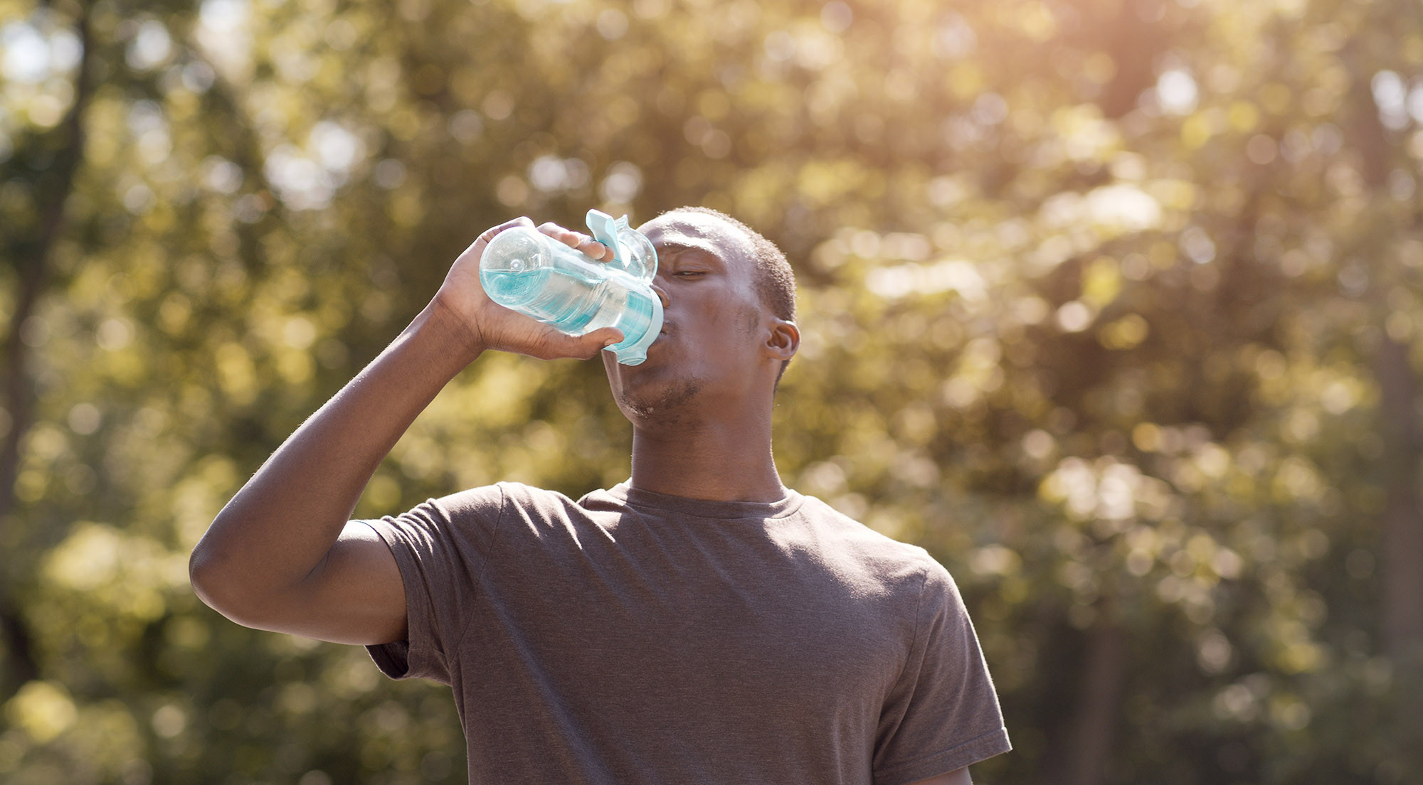 Man drinking water in hot weather